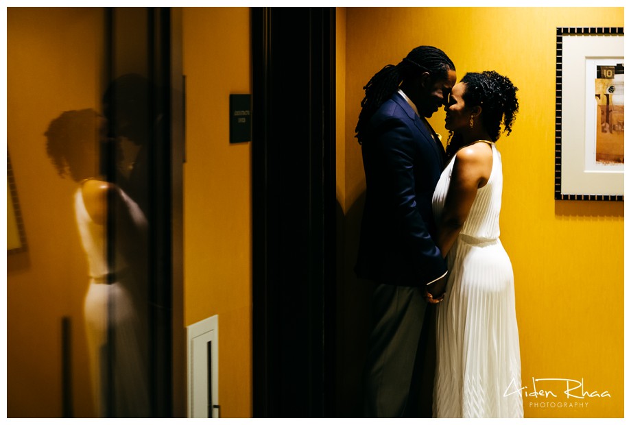 reflection of bride and groom on door glass
